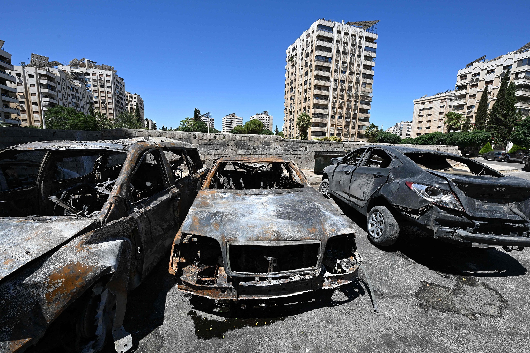 Charred cars lie in a parking lot in the aftermath of an Israeli strike in Damascus, Syria, July 14, 2024. /CFP