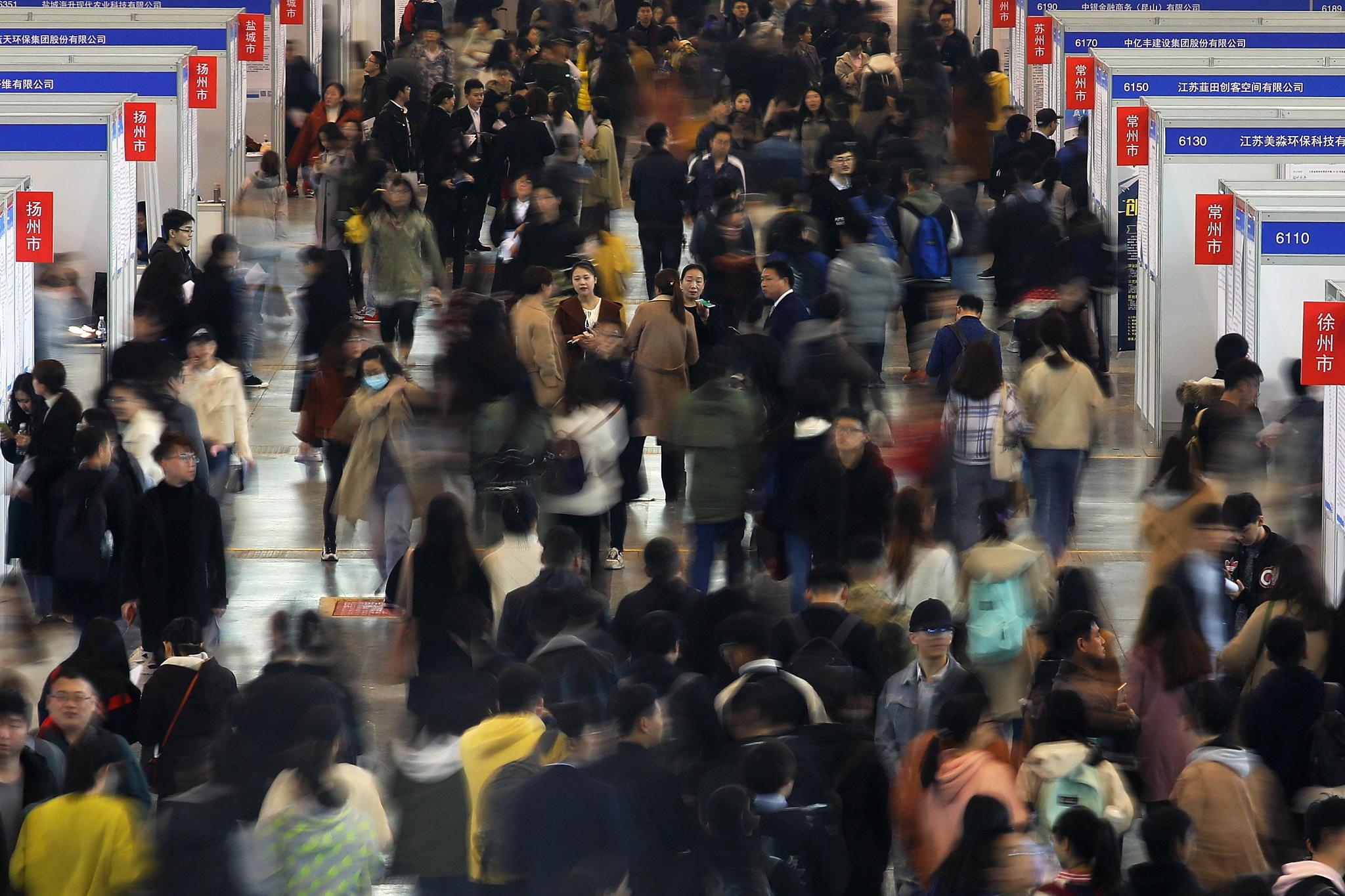 A bustling crowd navigates a job fair in China, where recent graduates explore employment opportunities amid a competitive job market. /CFP