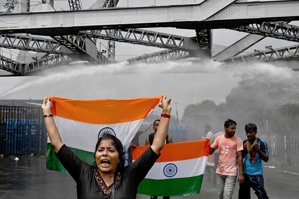 Police use water cannons to disperse activists carrying India's national flag as they march toward the state secretariat demanding the resignation of Mamata Banerjee, chief minister of West Bengal state, amid protests against the rape and murder of a doctor in Kolkata, India, August 27, 2024. /CFP