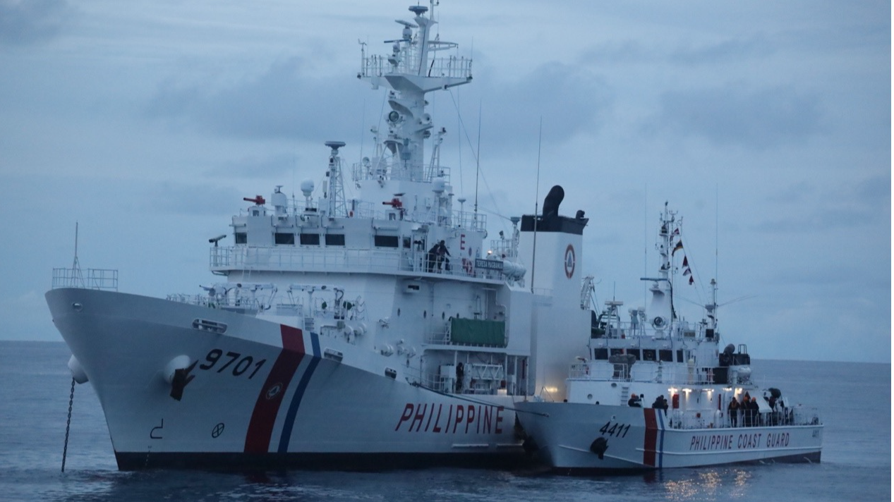 Two Philippine Coast Guard vessels anchored at Xianbin Jiao, moored side by side to create a semi-permanent floating platform, June 27, 2024. /CFP