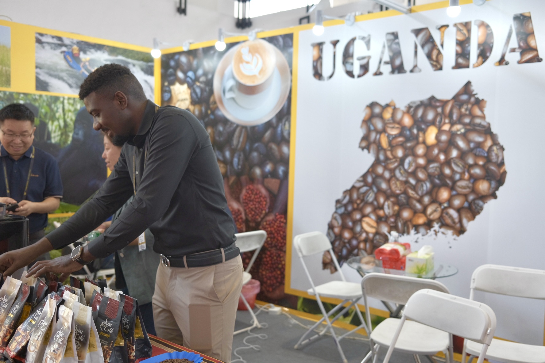 Amumpaire Frandan organizes coffee packages in the Uganda booth at the 2024 Cafe Show China, August 30, 2024. /CGTN