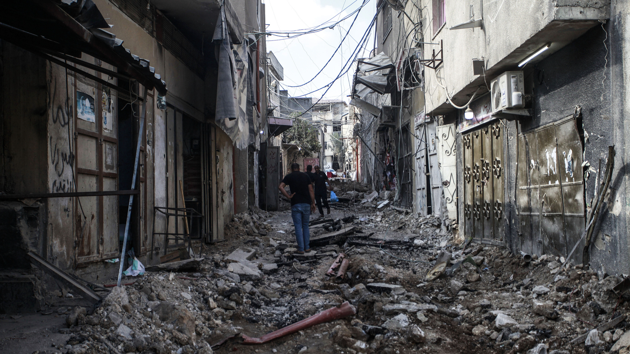 People walk amidst the devastation in the Nur Shams refugee camp near Tulkarem in the occupied West Bank in the aftermath of a large-scale Israeli military operation, August 30, 2024. /CFP