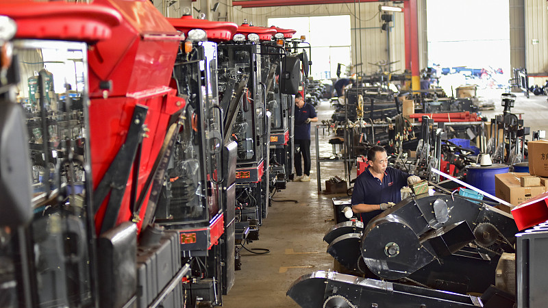 Workers on an assembly line at a corn combine harvester manufacturing company in Qingzhou Economic Development Zone, east China's Shandong Province, August 31, 2024. /CFP
