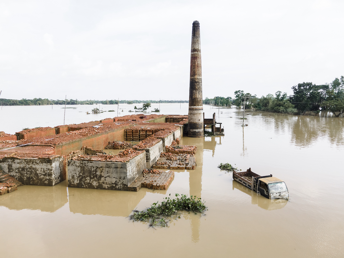 A brickyard and a car are half submerged in floodwater in Chittagong division, Bangladesh, August 29, 2024. /CFP