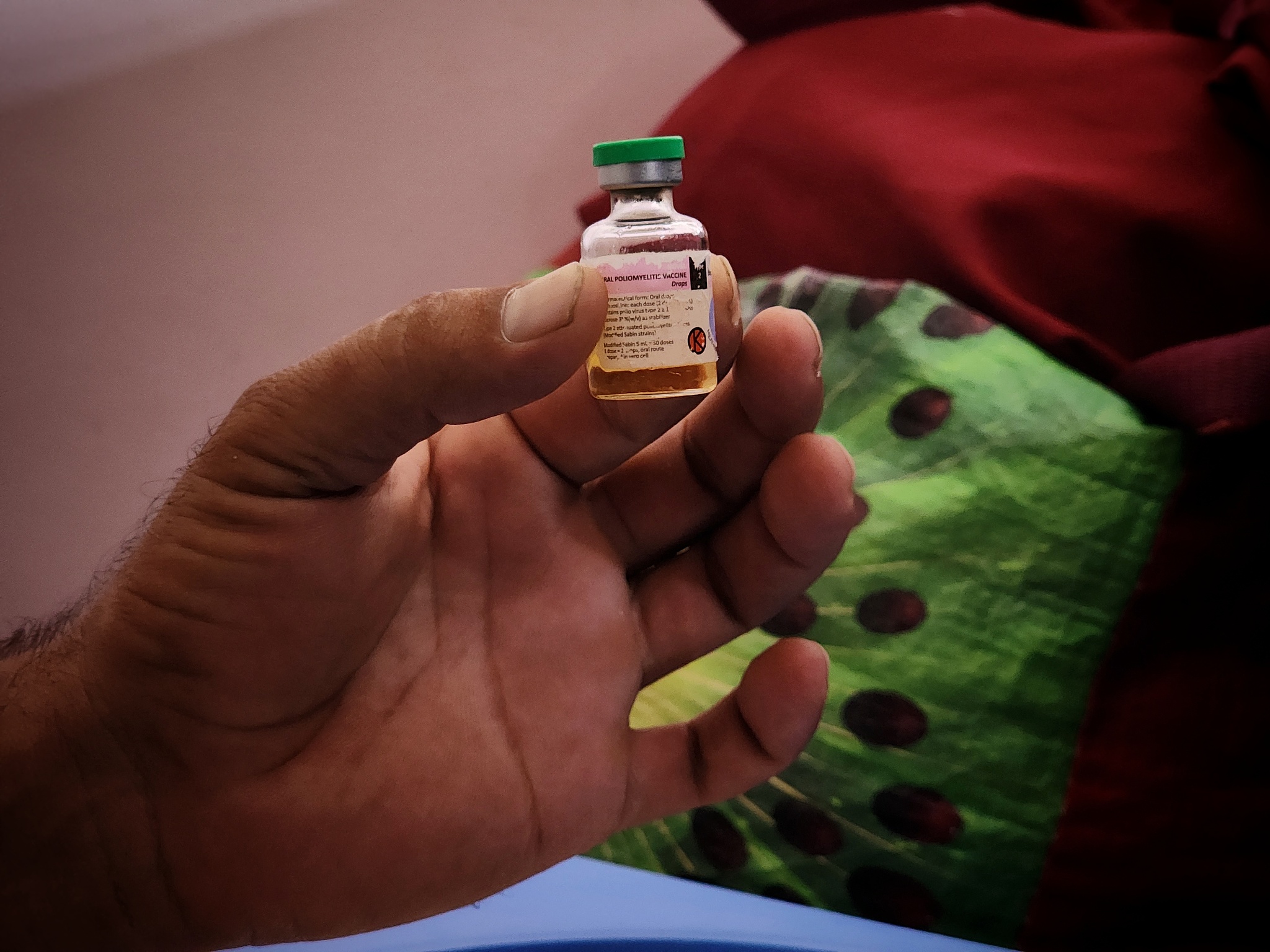 A worker holds the vaccine drops as children receive vaccination at Nasser Hospital in Khan Yunis, Gaza, August 31, 2024. /CFP