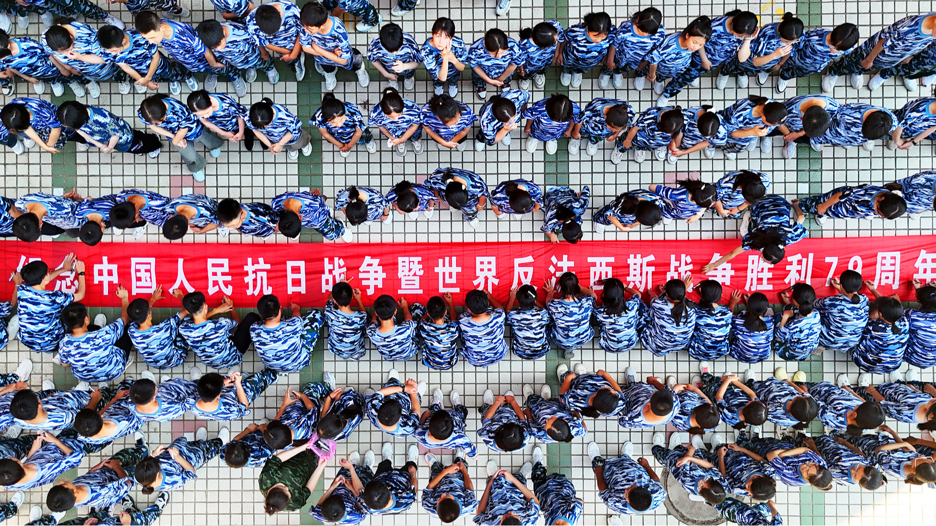 Students from a middle school signing a banner that says 