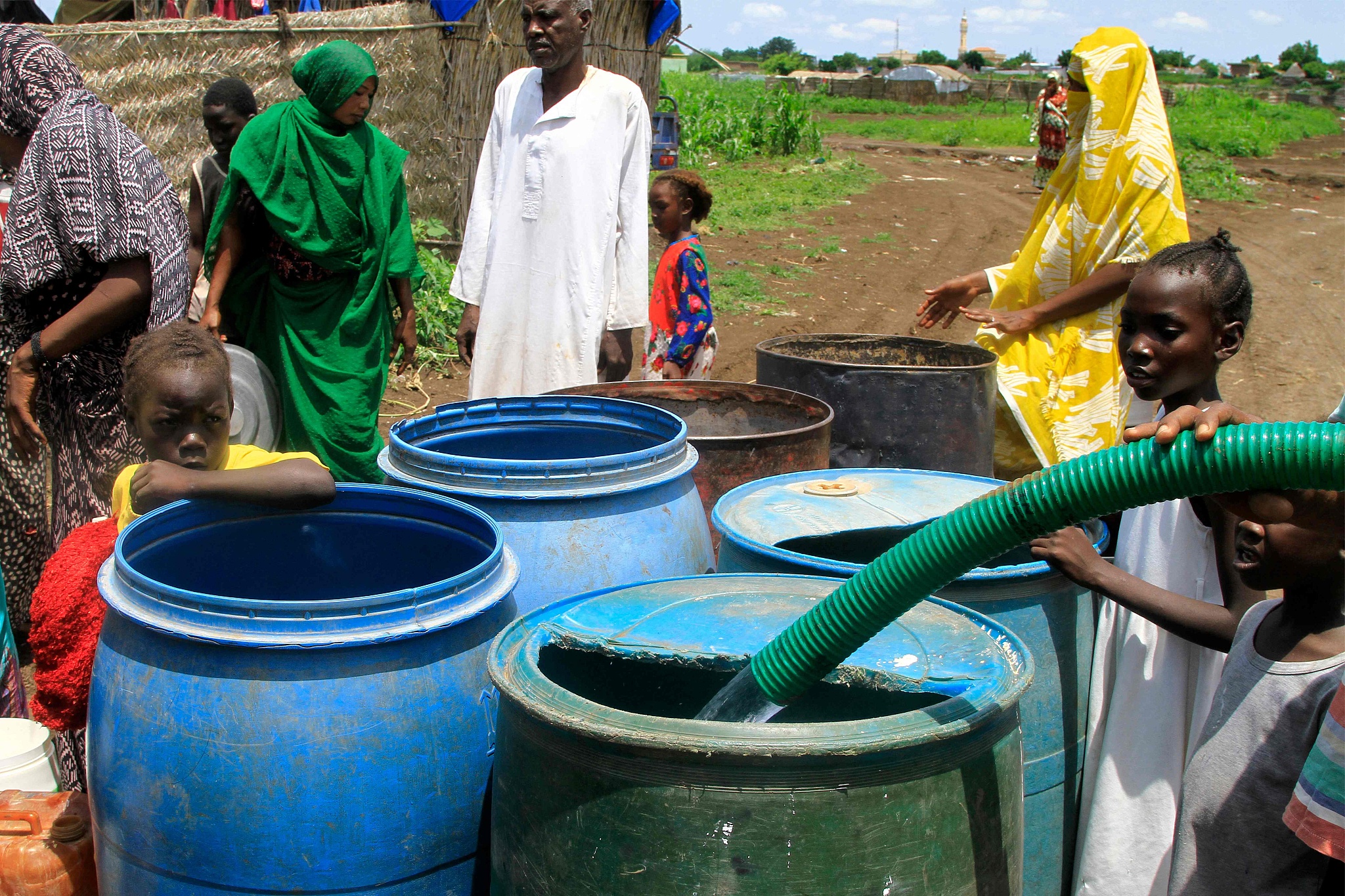 People collect clean water provided by a charity organization to people in eastern Sudan, August 30, 2024. /CFP