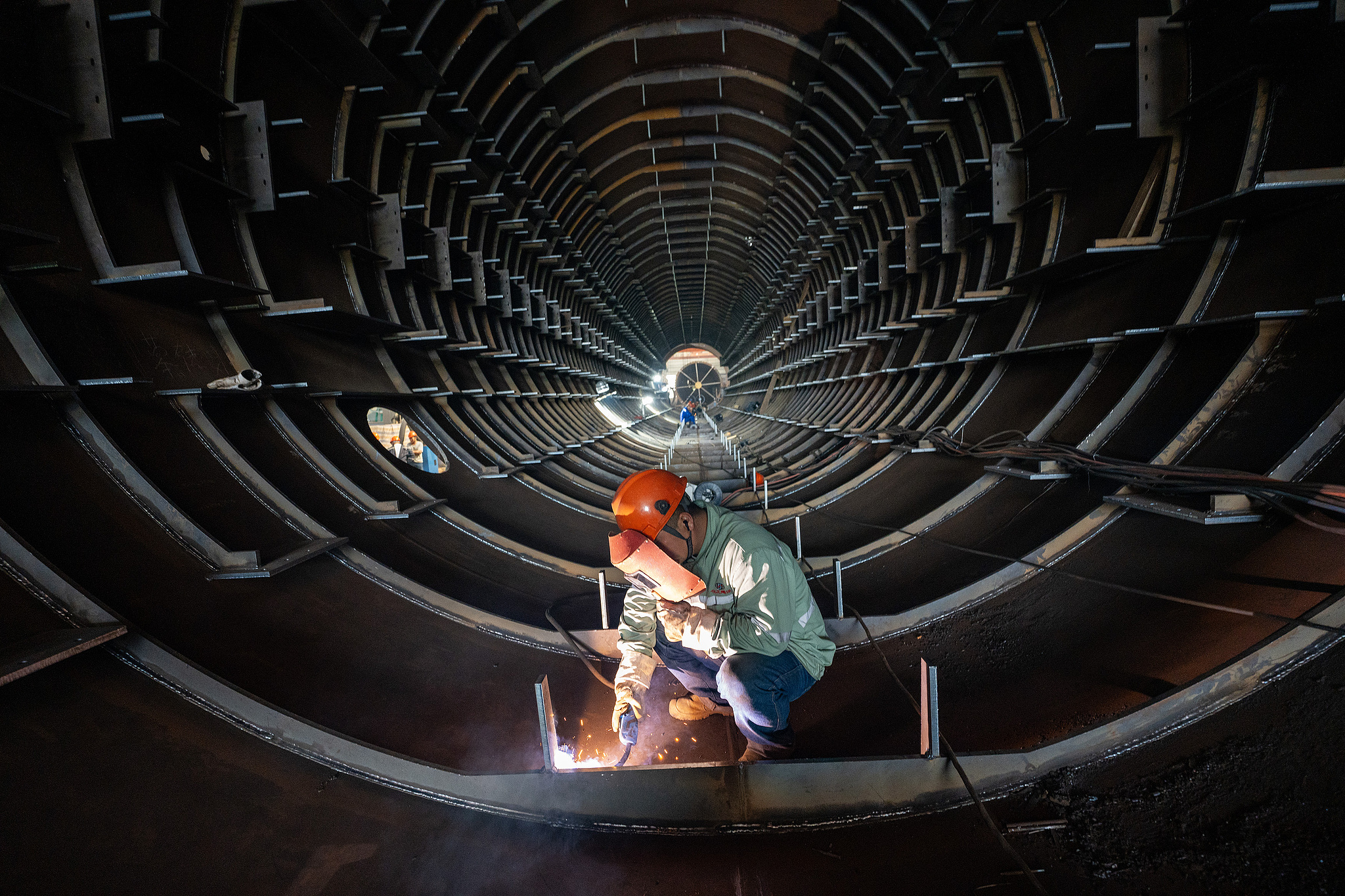 Workers welding parts for large towers in a workshop in Nantong, east China's Jiangsu Province, September 1, 2024. /CFP