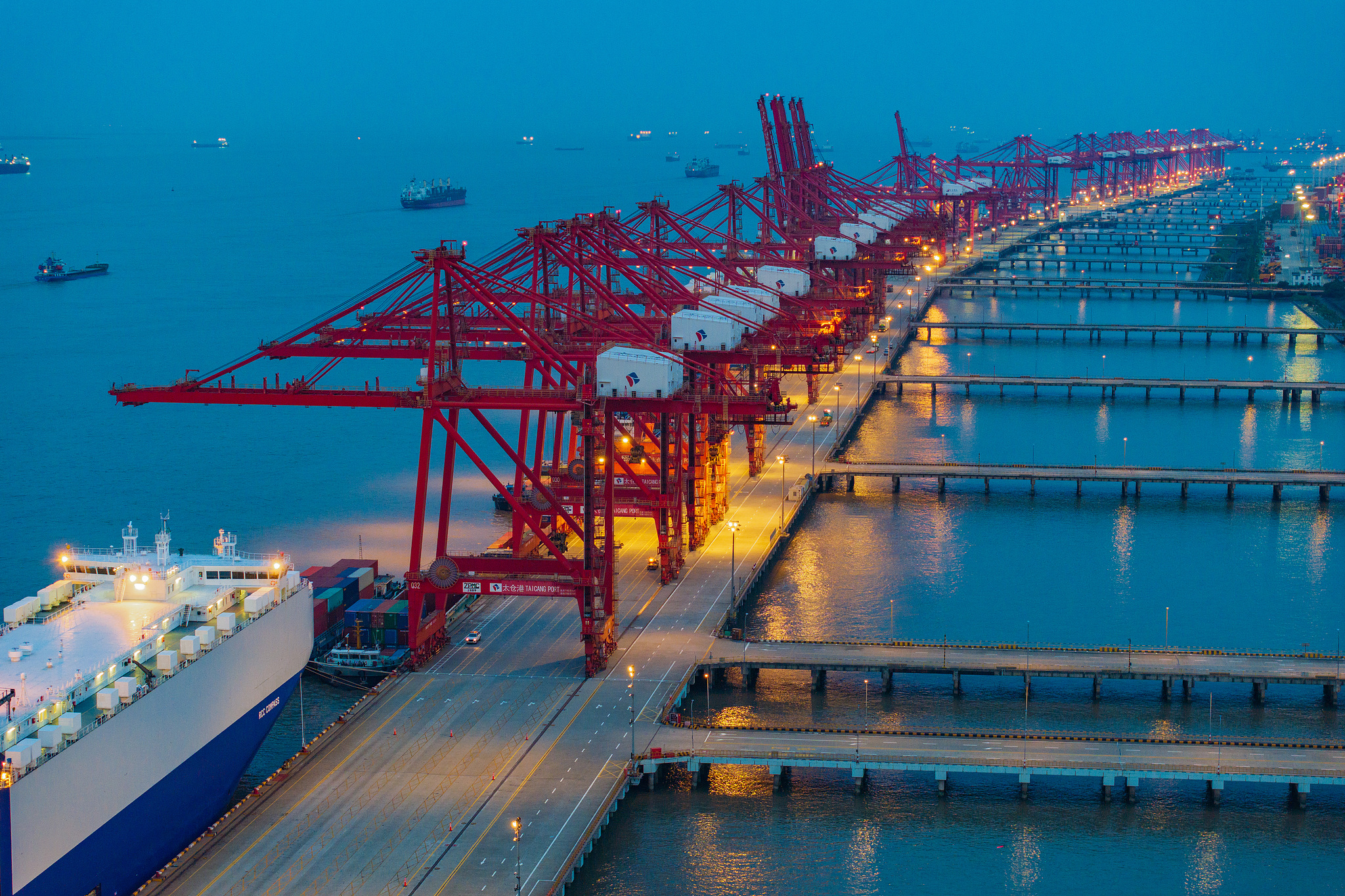 The international container terminal in Taicang Port of Suzhou was lit up as the export business of new energy vehicles entered its busy peak period, Jiangsu Province, China, July 9, 2024. /CFP