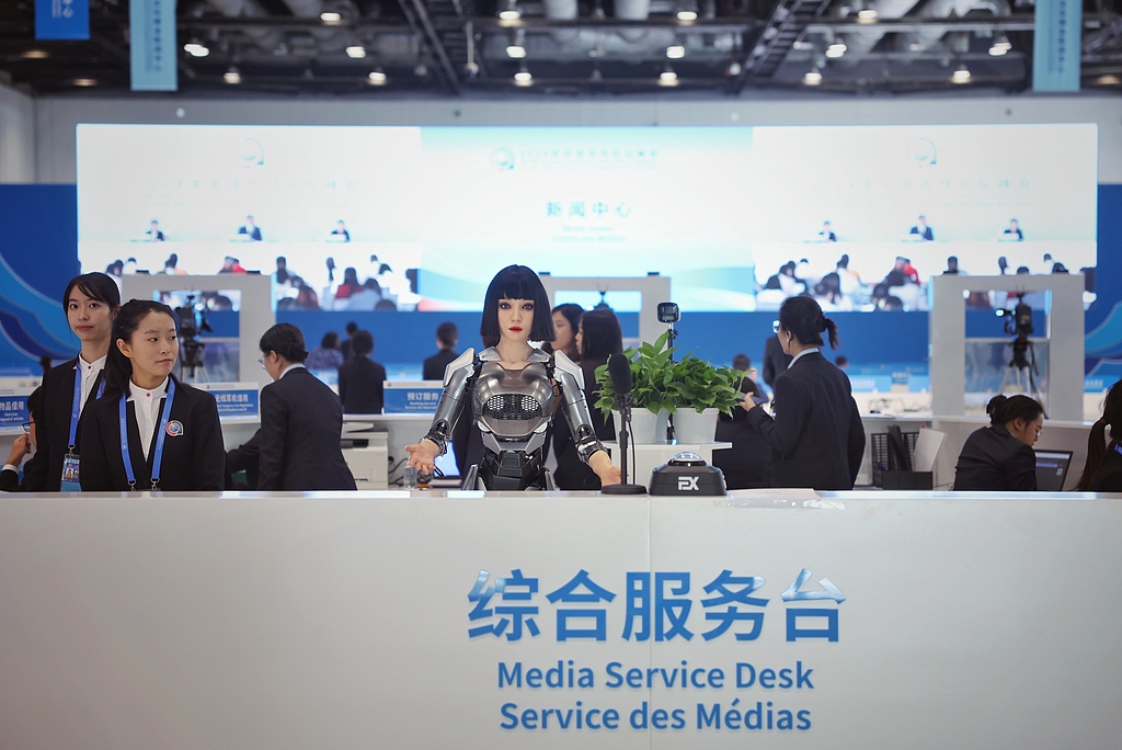 A humanoid robot greets visitors at the media center reception desk for the 2024 Summit of the Forum on China-Africa Cooperation (FOCAC) in Beijing, September 3, 2024. /CFP