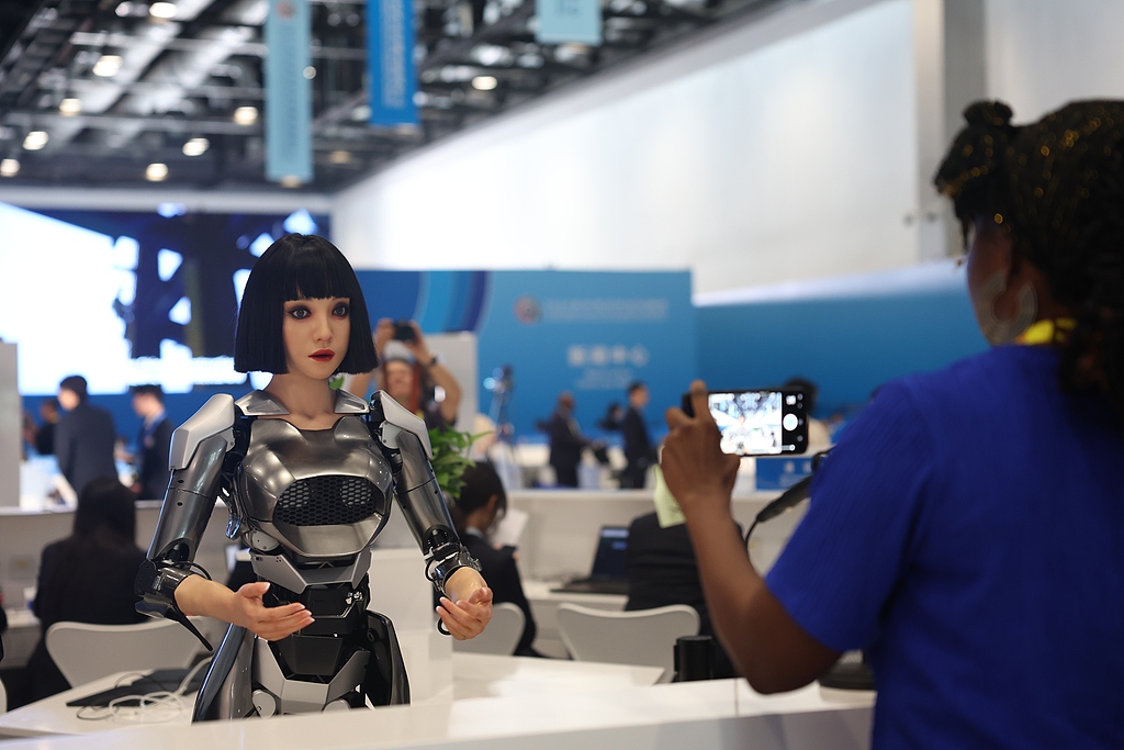 A humanoid robot greets visitors at the media center reception desk for the 2024 Summit of the Forum on China-Africa Cooperation (FOCAC) in Beijing, September 3, 2024. /CFP