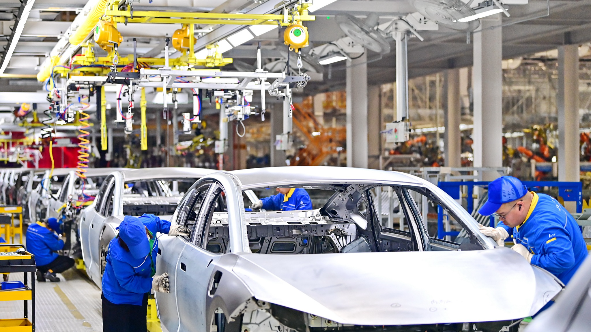 Workers on the production line of electric vehicles in Nanchang City, east China's Jiangxi Province, April 2, 2024. /CFP