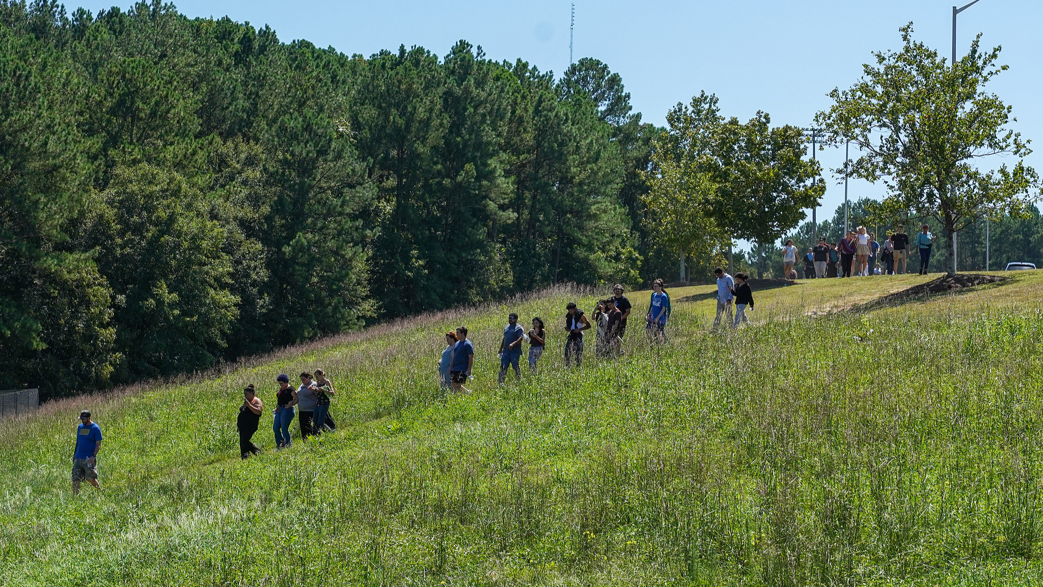 Students walk off campus with their families after a shooting at Apalachee High School in Winder, Georgia, U.S., September 4, 2024. /CFP