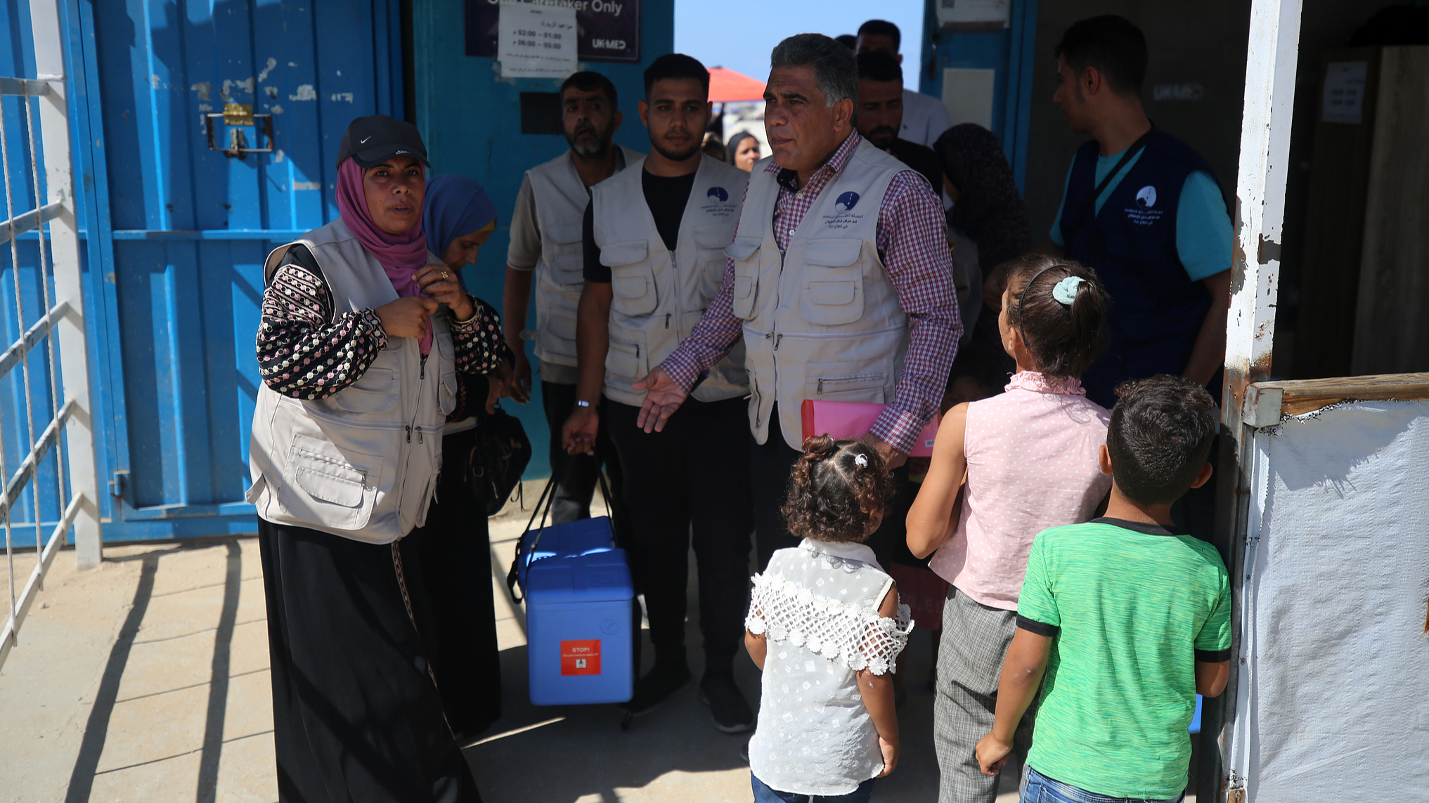 Health workers carry containers filled with polio vaccines during a vaccination campaign at the UK-MED field hospital in Khan Younis in the southern Gaza Strip, September 5, 2024. /CFP