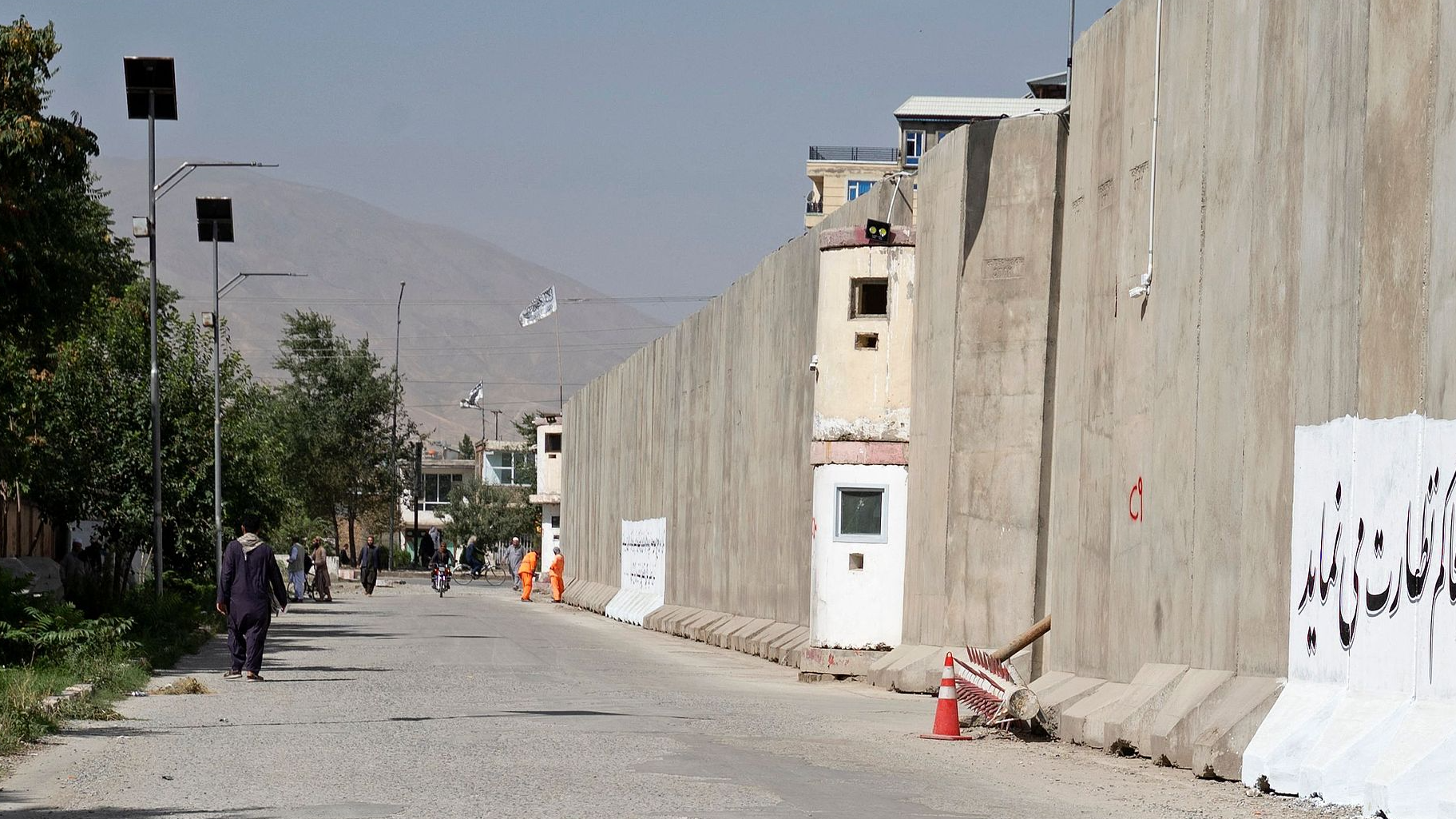 Afghan men walk near the site a day after a suicide bomber triggered explosives in front of the General Directorate for Monitoring and Follow-up of Decrees and Directives, in Kabul, September 3, 2024. /CFP