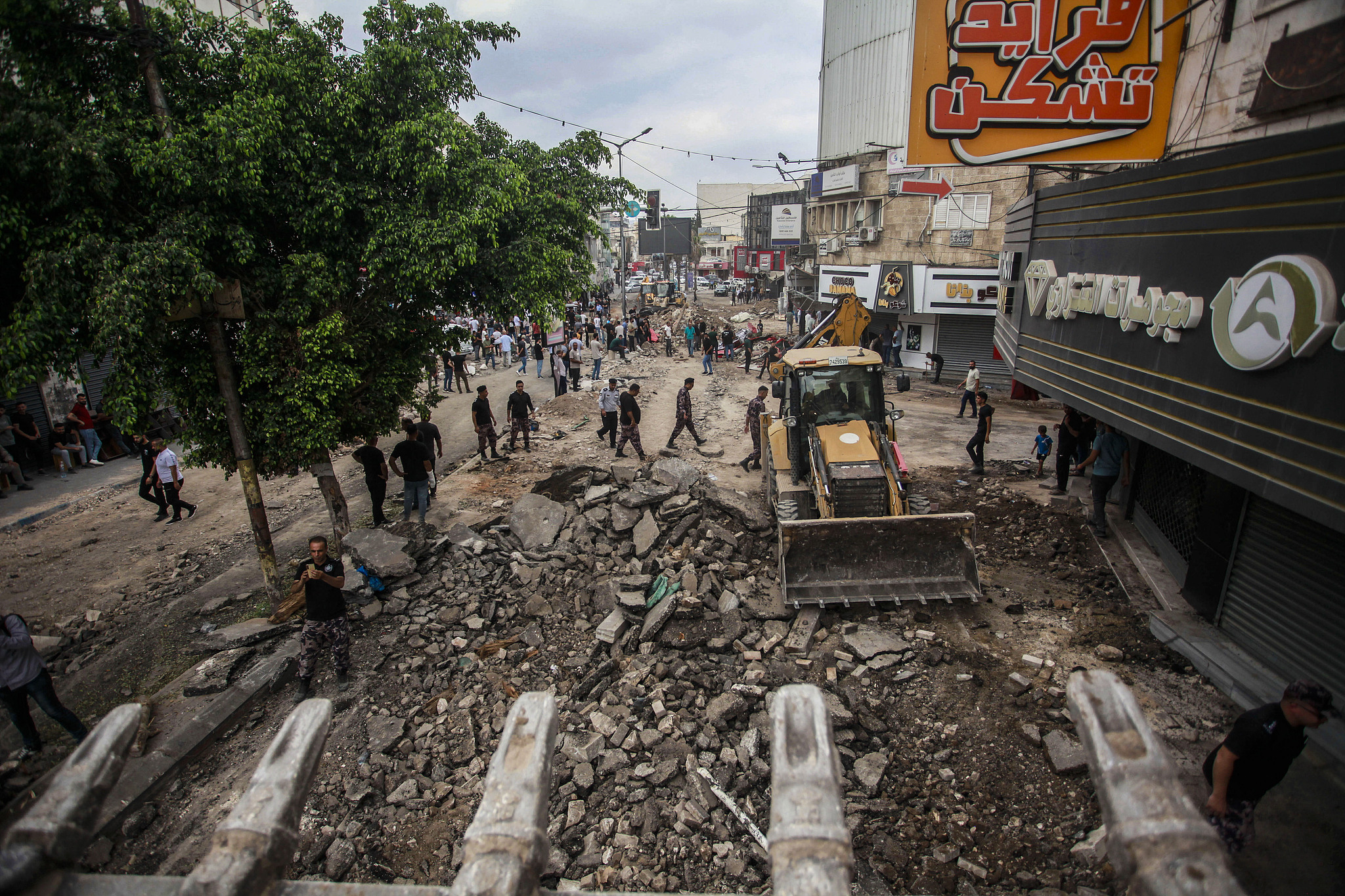 Palestinians walk around damaged infrastructure in the city center of Jenin following an Israeli military raid on the Jenin refugee camp, September 6, 2024. /CFP