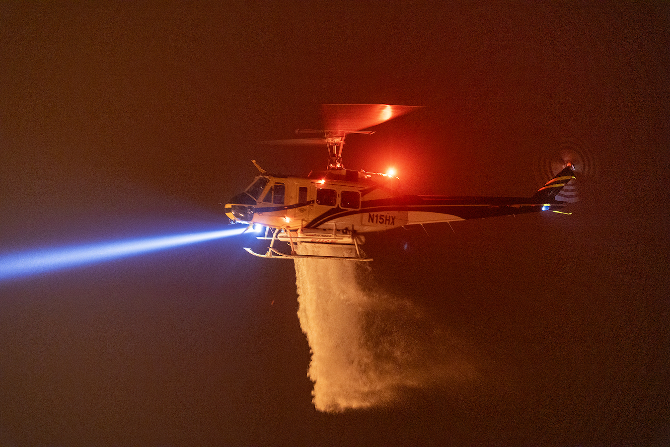 A helicopter drops water over the mountains, California the United States, September 7, 2024. /CFP