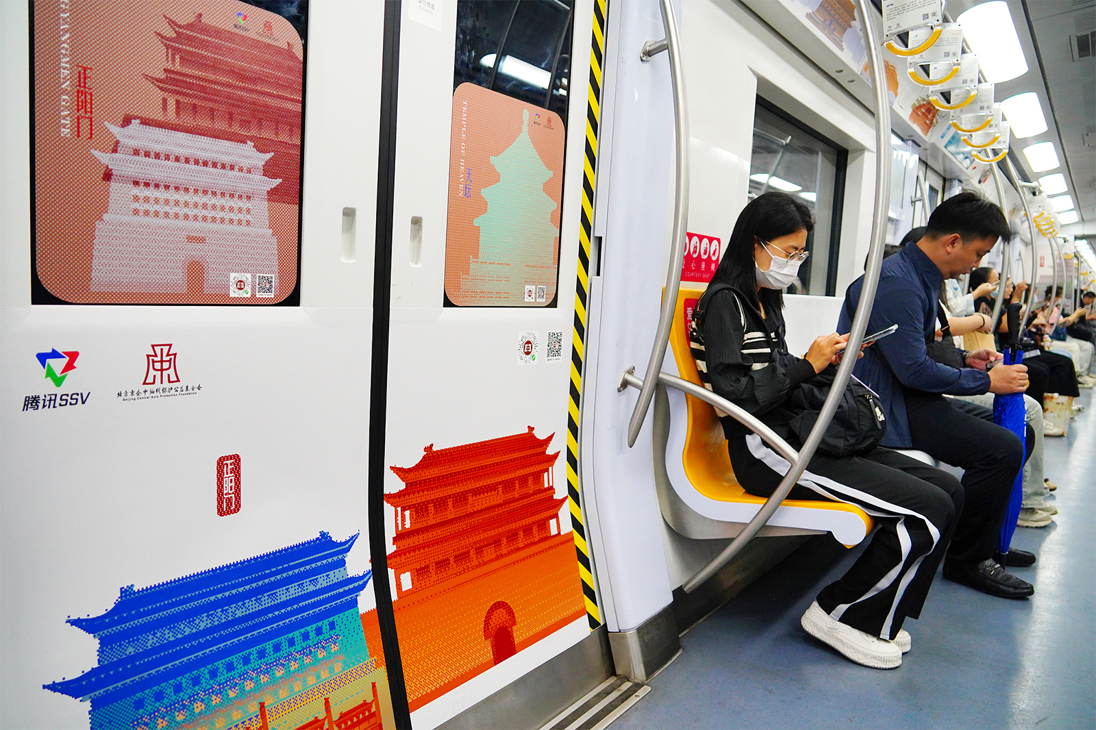 Passengers take the Beijing Central Axis-themed subway train in Beijing on September 9, 2024. /CFP