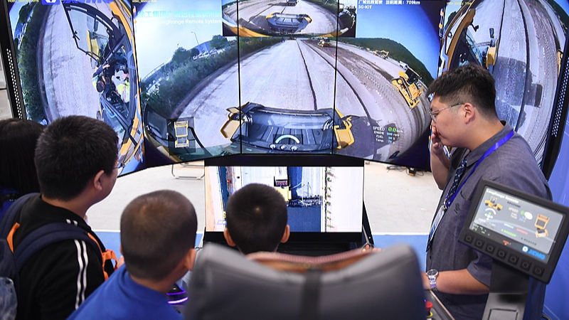 A student operates a remote driving system at the 2024 Beijing Science and Technology Week in Shougang Park, Shijingshan District, Beijing, China, May 25, 2024. /CFP