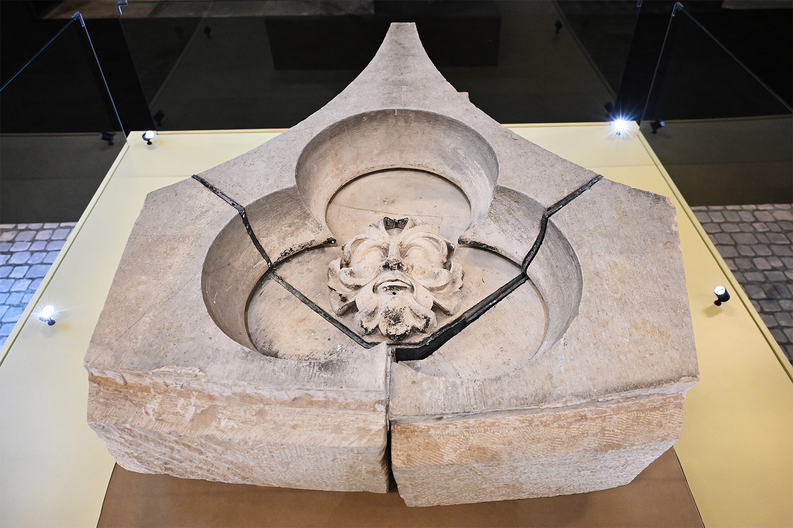 A carving of a human face covered in vegetation is displayed at an exhibition on the history and restoration of Notre-Dame de Paris at the National Museum of China in Beijing on September 11, 2024. /CFP