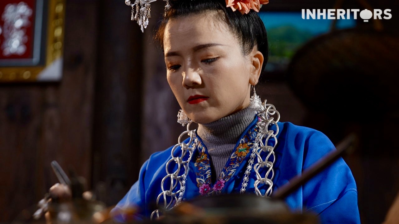 A female Miao silversmith makes silver jewelry pieces. /CGTN