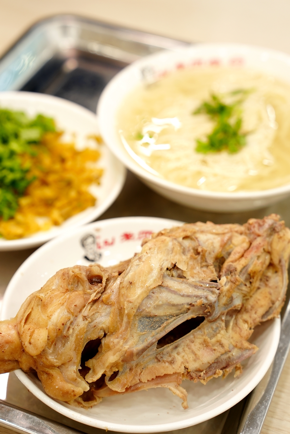 A standard set consists of a chicken carcass, noodles, soup, coriander and some pickles. /CGTN