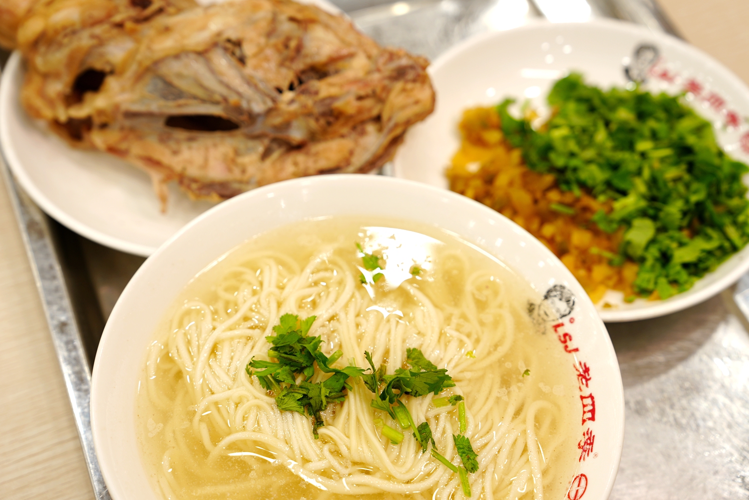 A standard set consists of a chicken carcass, noodles, soup, coriander and some pickles. /CGTN