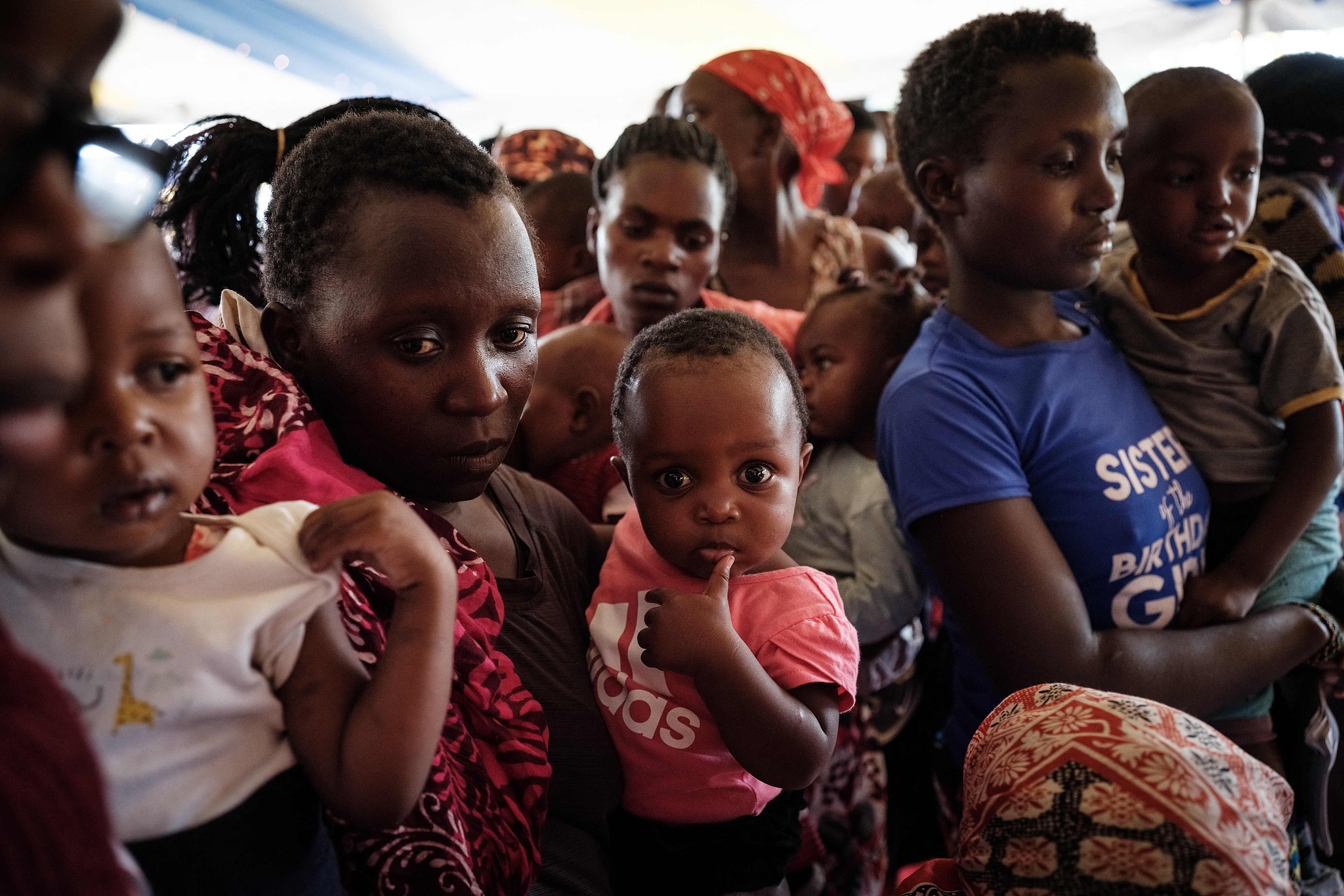 Mothers and children wait to receive a shot during the launch of the extension of the world's first malaria vaccine pilot program for children at risk of malaria illness and death, in Gisambai, Kenya, March 7, 2023. /CFP