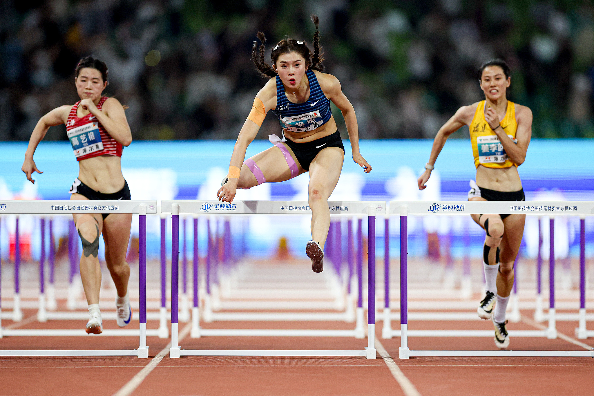 Wu Yanni (C) of China competes in the women's 100m hurdles during the National Athletics Championships in Quzhou, China, September 16, 2024. /CFP