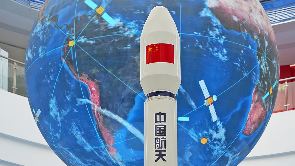 A model of China's carrier rocket with the BeiDou navigation system in background. /CFP