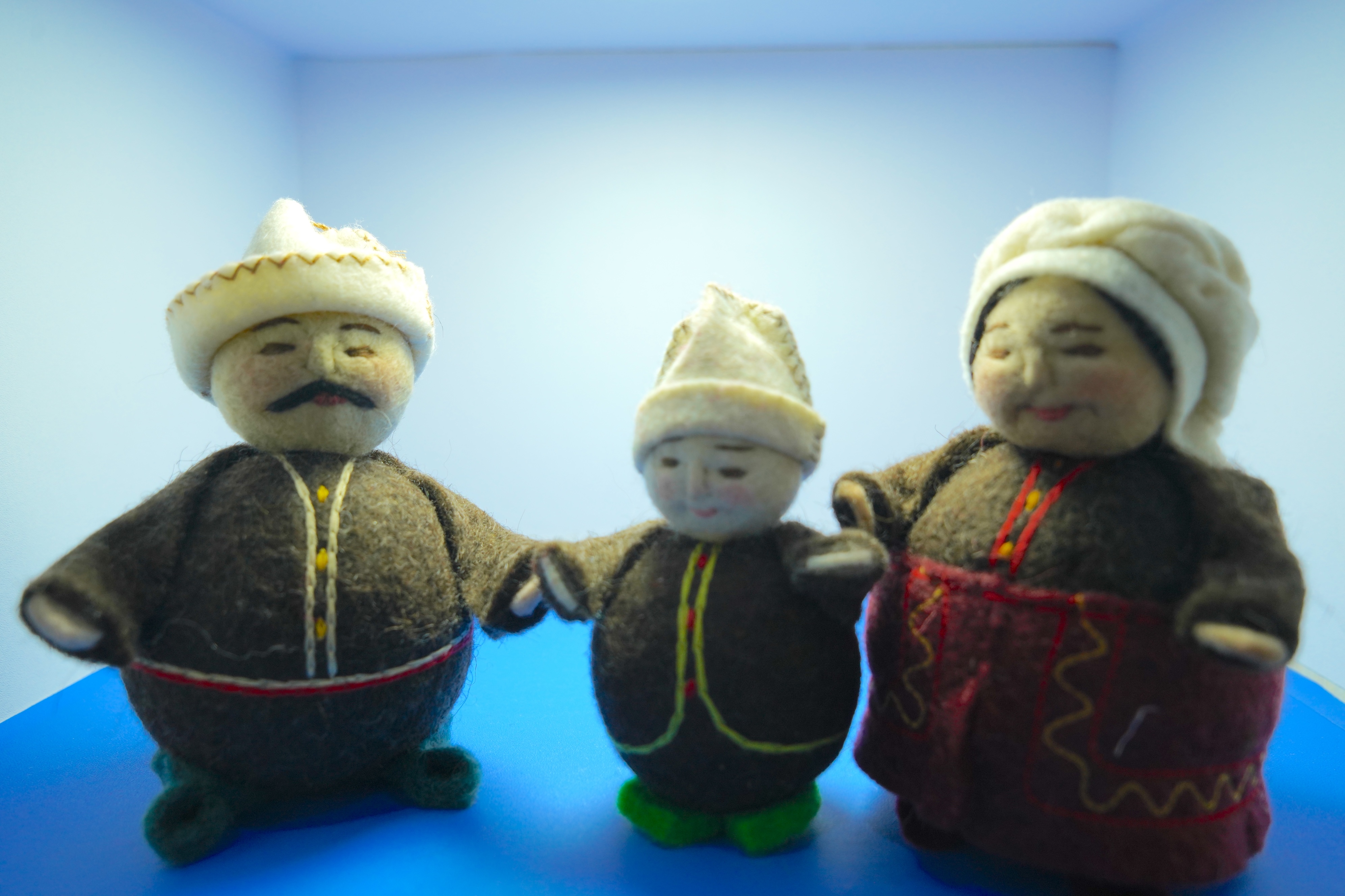 Figurines crafted using the felt and cloth embroidery techniques of the Kazakh ethnic group are showcased at an intangible cultural heritage exhibition in Xinjiang. /CGTN