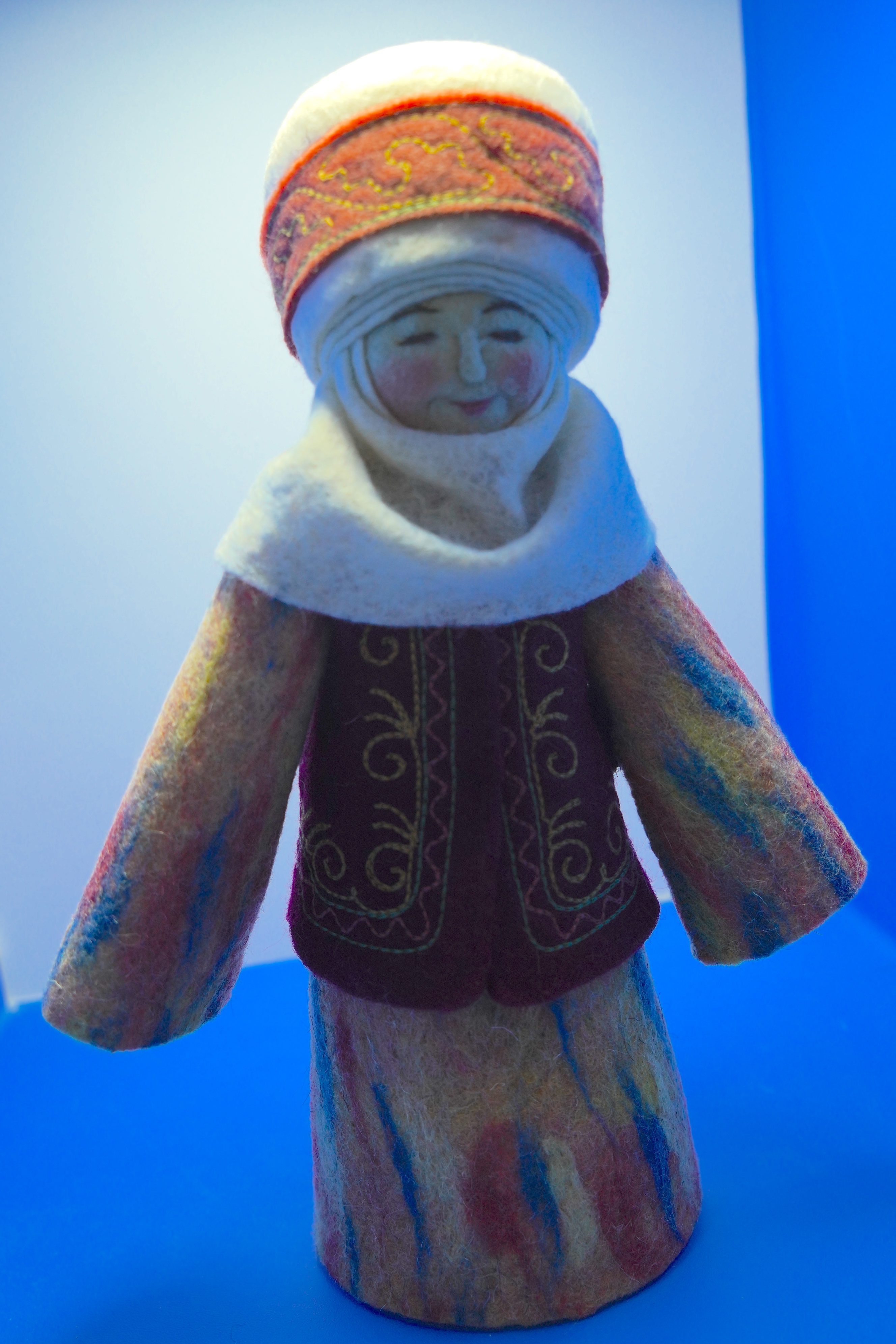 A figurine crafted using the felt and cloth embroidery techniques of the Kazakh ethnic group is showcased at an intangible cultural heritage exhibition in Xinjiang. /CGTN