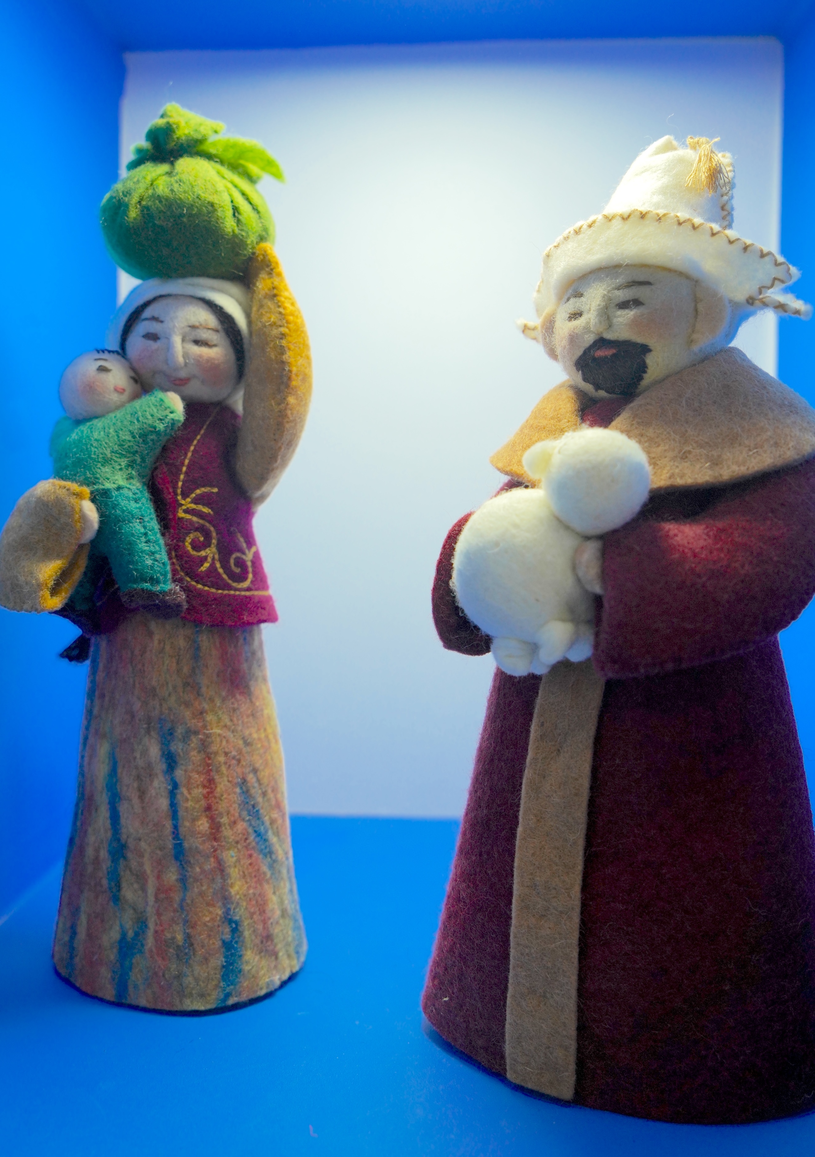 Figurines crafted using the felt and cloth embroidery techniques of the Kazakh ethnic group are showcased at an intangible cultural heritage exhibition in Xinjiang. /CGTN