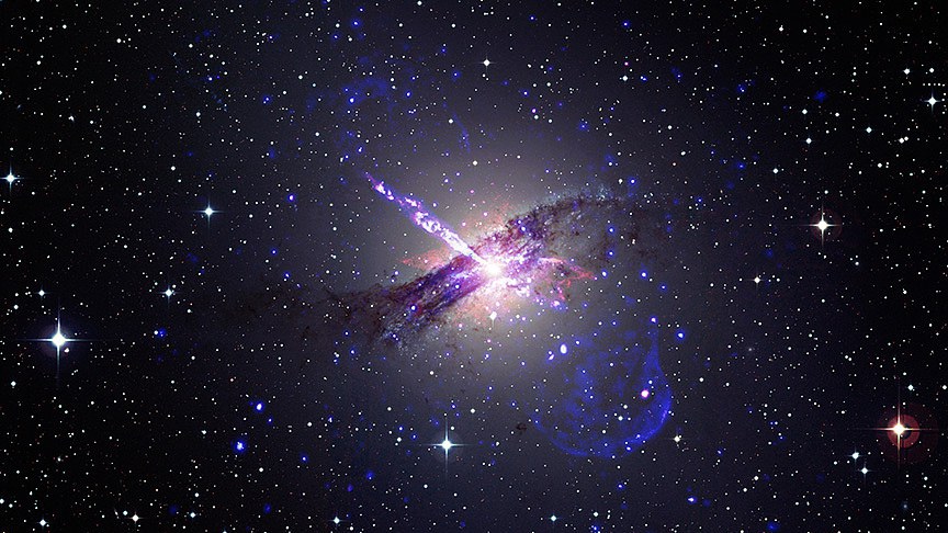 A composite image shows that a supermassive black hole at the center of the Centaurus A galaxy shoots an enormous jet of particles into a star-packed sky. /CFP