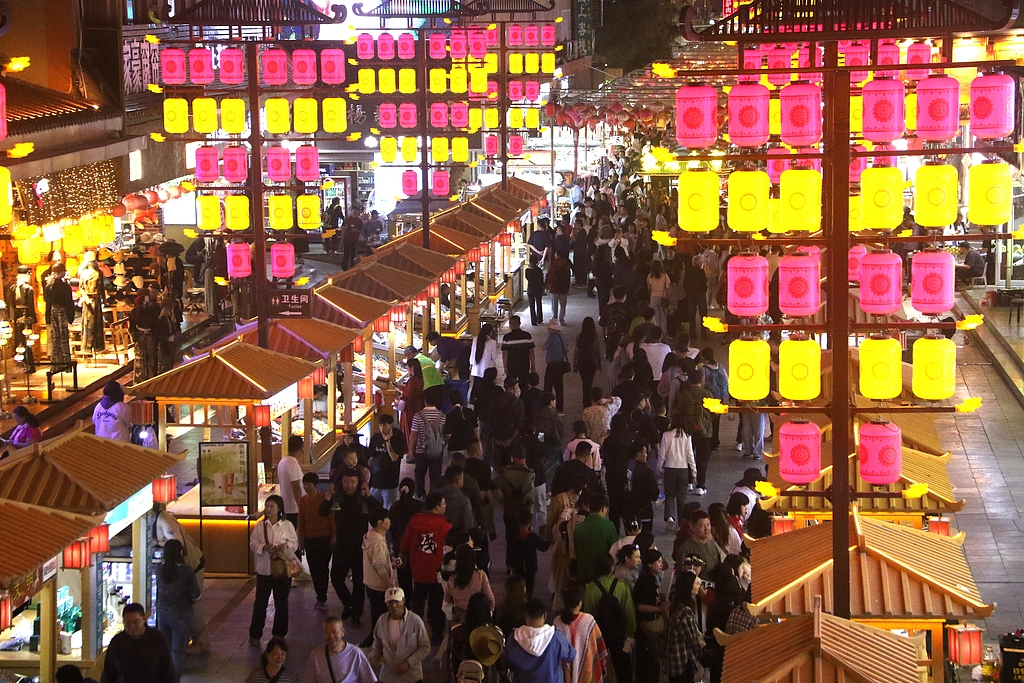 People visit the night markets at the Mingsha Mountain and Crescent Spring scenic spot in Dunhuang, Gansu Province, September 16, 2024. /CFP