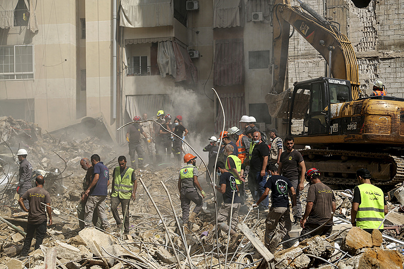 Civil defense workers are seen at the site of the Israeli air raid attack in Beirut's southern suburbs, Lebanon, September 21, 2024. /CFP