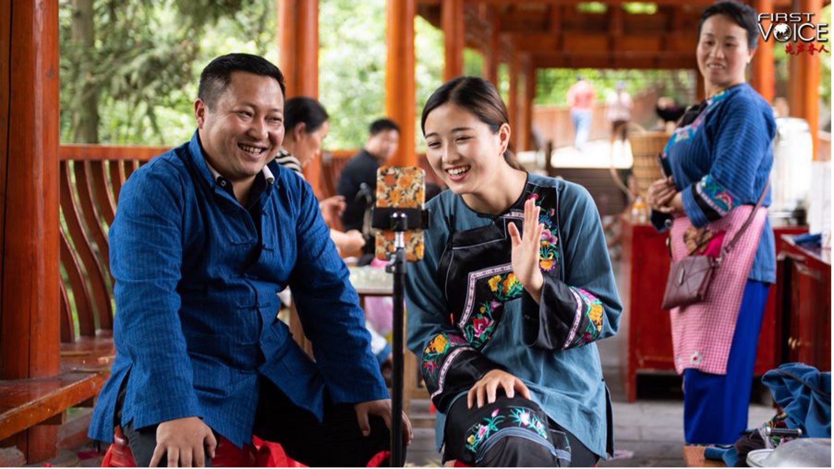 Ma Huihuang (Left), leader of the poverty relief team of Shibadong Village, together with villager Shi Linjiao, promotes local products via live streaming at Shibadong Village of Xiangxi Tujia and Miao Autonomous Prefecture, central China's Hunan Province, May 15, 2020. /Xinhua