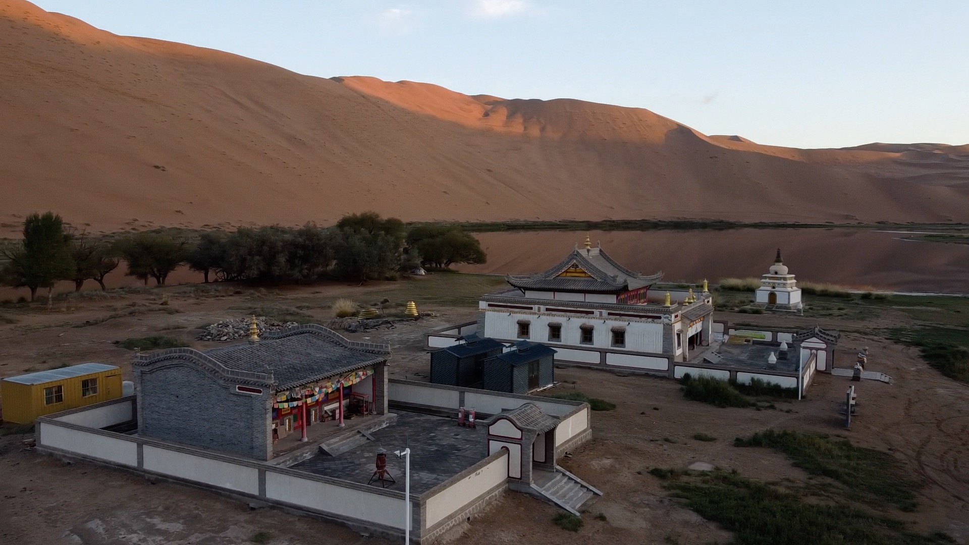 A photo taken on September 22, 2024 shows Badain Jaran temple situated on a lakeside. /CGTN