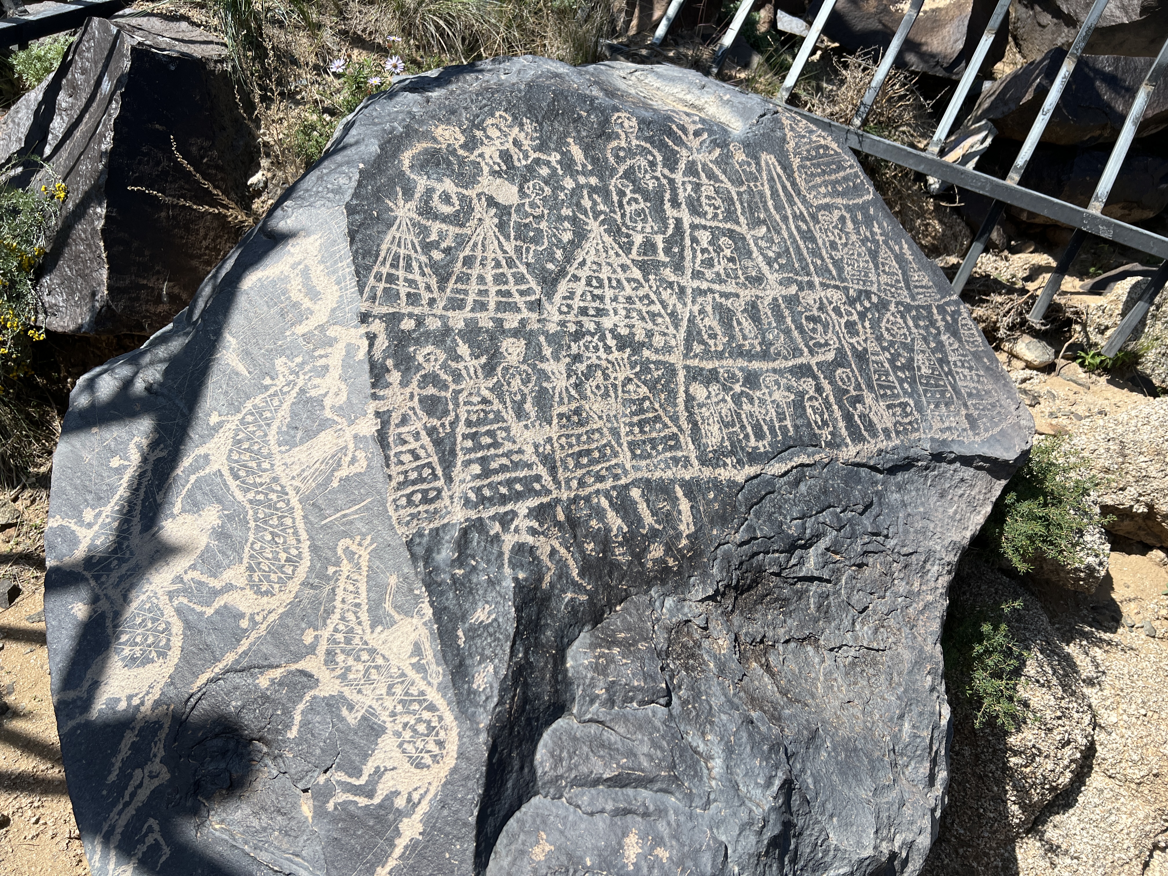 A photo taken on September 22, 2024 shows a rock painting in the Mandela Mountains in Alxa Right Banner in North China's Inner Mongolia Autonomous Region. The carvings depict a matriarchal village of 18 tents and their inhabitants, with the tallest figure being that of a woman. /CGTN