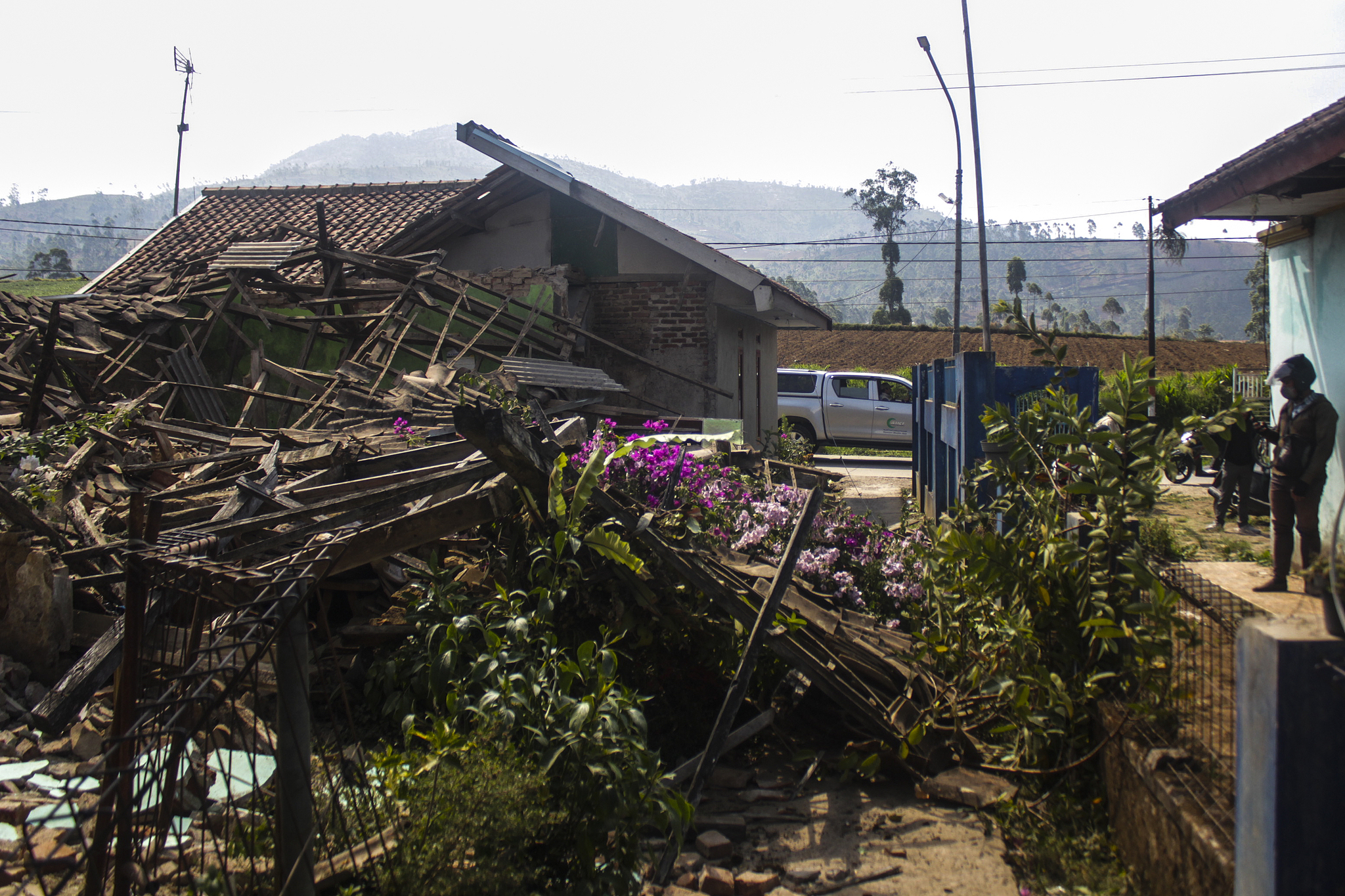 A resident stands in front of a house that was badly damaged after a magnitude-5 earthquake hit Cibereum Village, Bandung Regency, West Java, Indonesia, September 18, 2024. /CFP