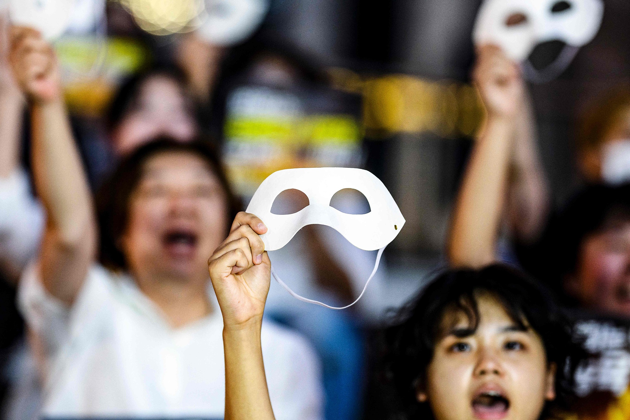 Activists shout slogans and hold up masks during a protest against deepfake porn in Seoul, August 30, 2024. /CFP