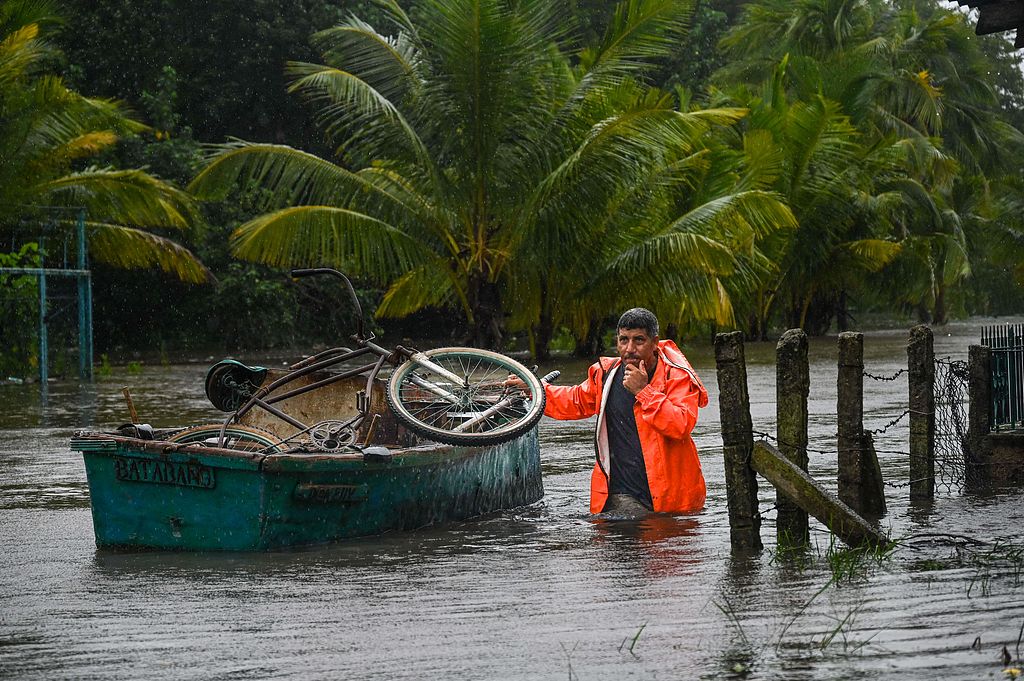 A resident transports his personal belongings in a boat on a flooded street after the passage of Hurricane Helene in Guanimar Town, Artemisa Province, Cuba, September 25, 2024. /CFP