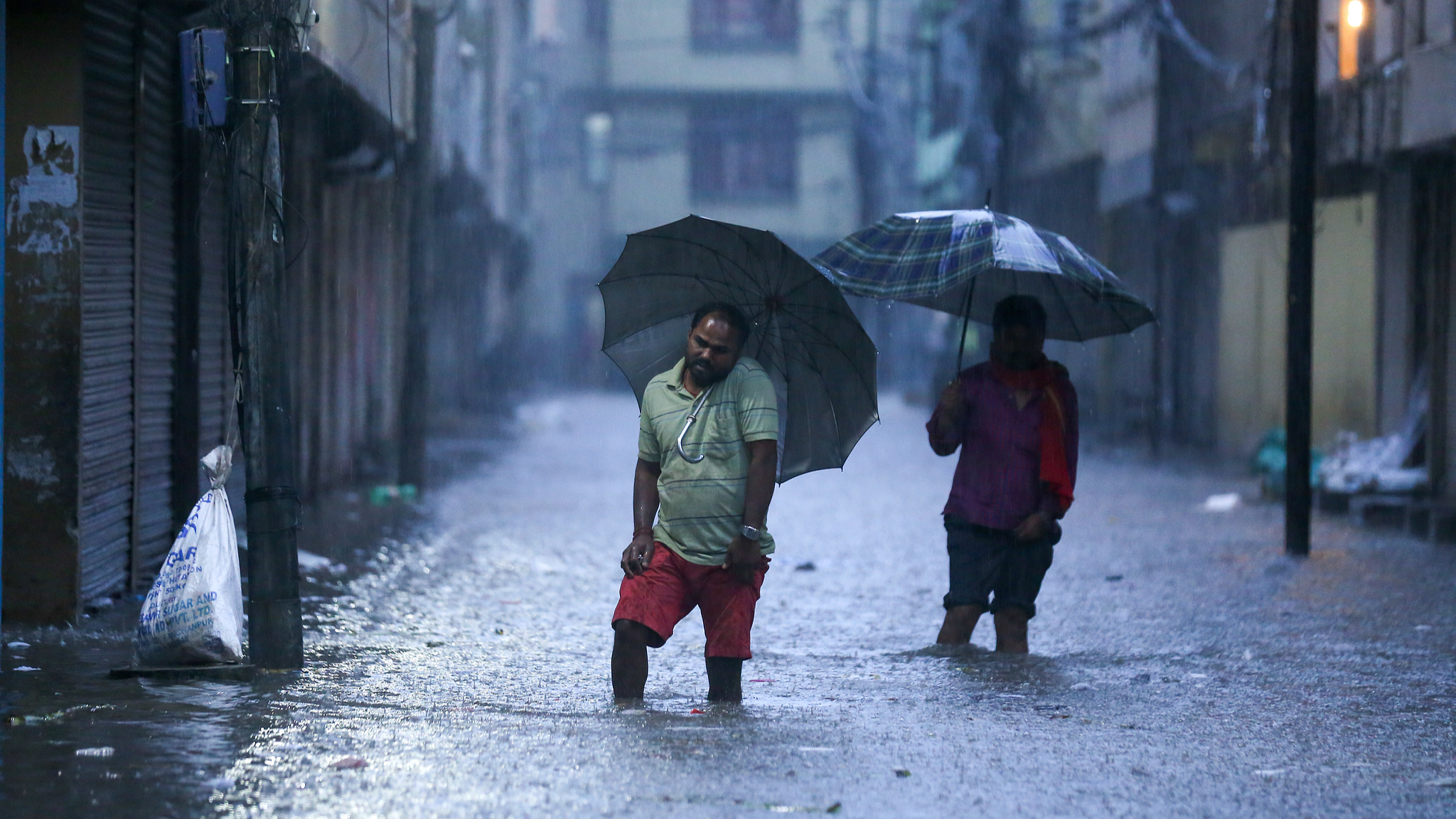 People wade through the flood water in Kathmandu, Nepal, September 27, 2024. /CFP