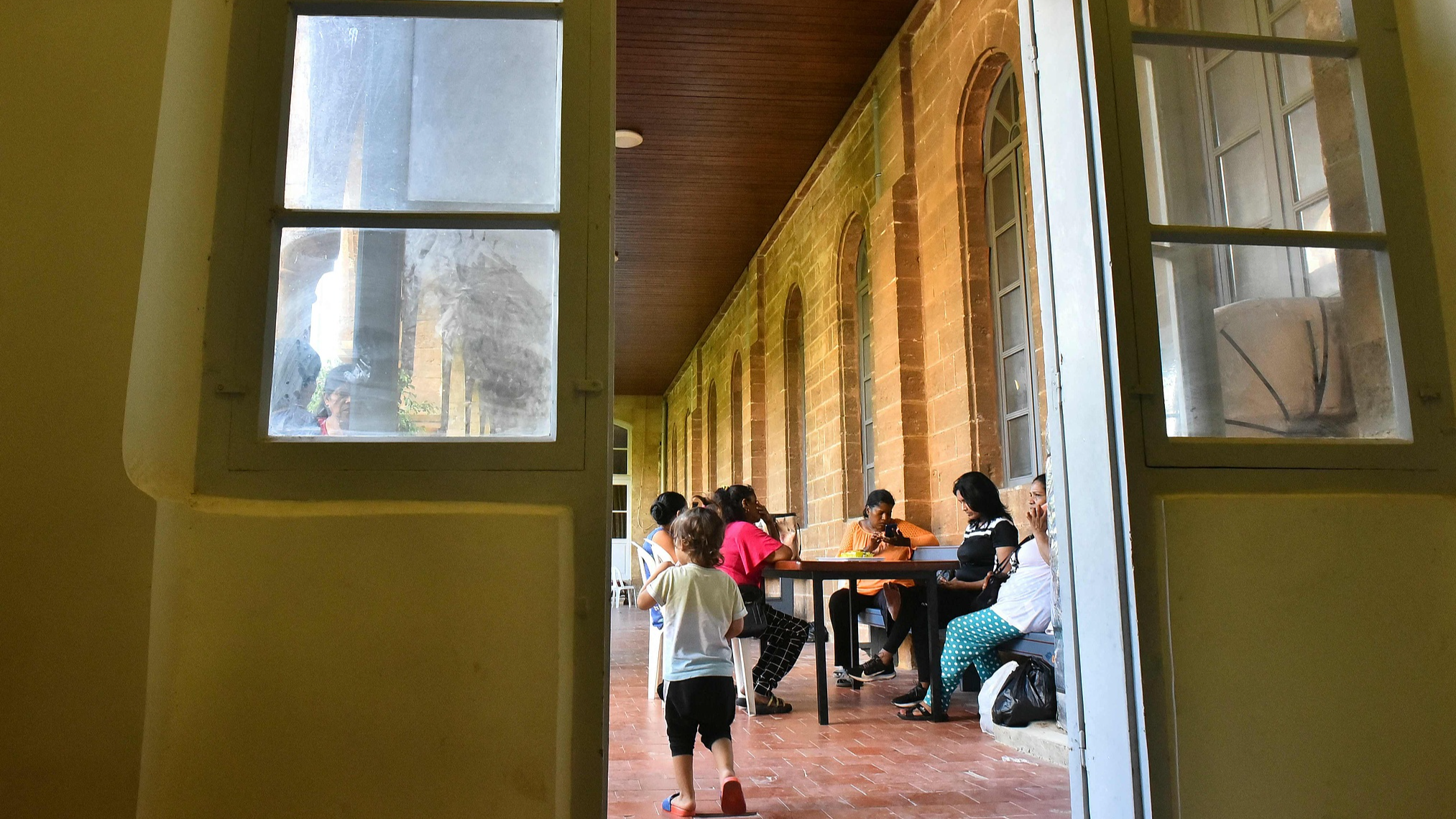 Migrant workers and their families arrive at the Saint Joseph Jesuits Fathers Church, which has been converted into a shelter for families fleeing their homes due to Israeli attacks in Lebanon's capital, Beirut, September 29, 2024. /CFP