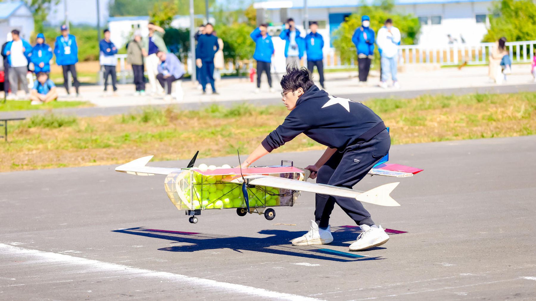 A contestant launches an aircraft during the 2024 China University Aircraft Design Competition, Dingzhou City, Hebei Province, north China, October 1, 2024. /Chinese Society of Aeronautics and Astronautics, 2024 China University Aircraft Design Competition