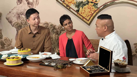 CGTN host Gasthoori Manickam (C) conducts an interview with an Intangible Cultural Heritage Inheritor of Suzhou's Yangcheng Lake Hairy Crab Cooking Techniques, Suzhou, Jiangsu Province. September 17, 2024. /CGTN