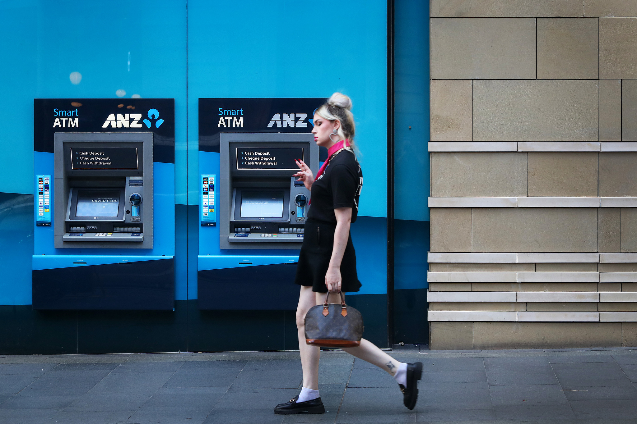 A pedestrian walks past ANZ ATMs in Sydney, Australia, February 26, 2024. /CFP