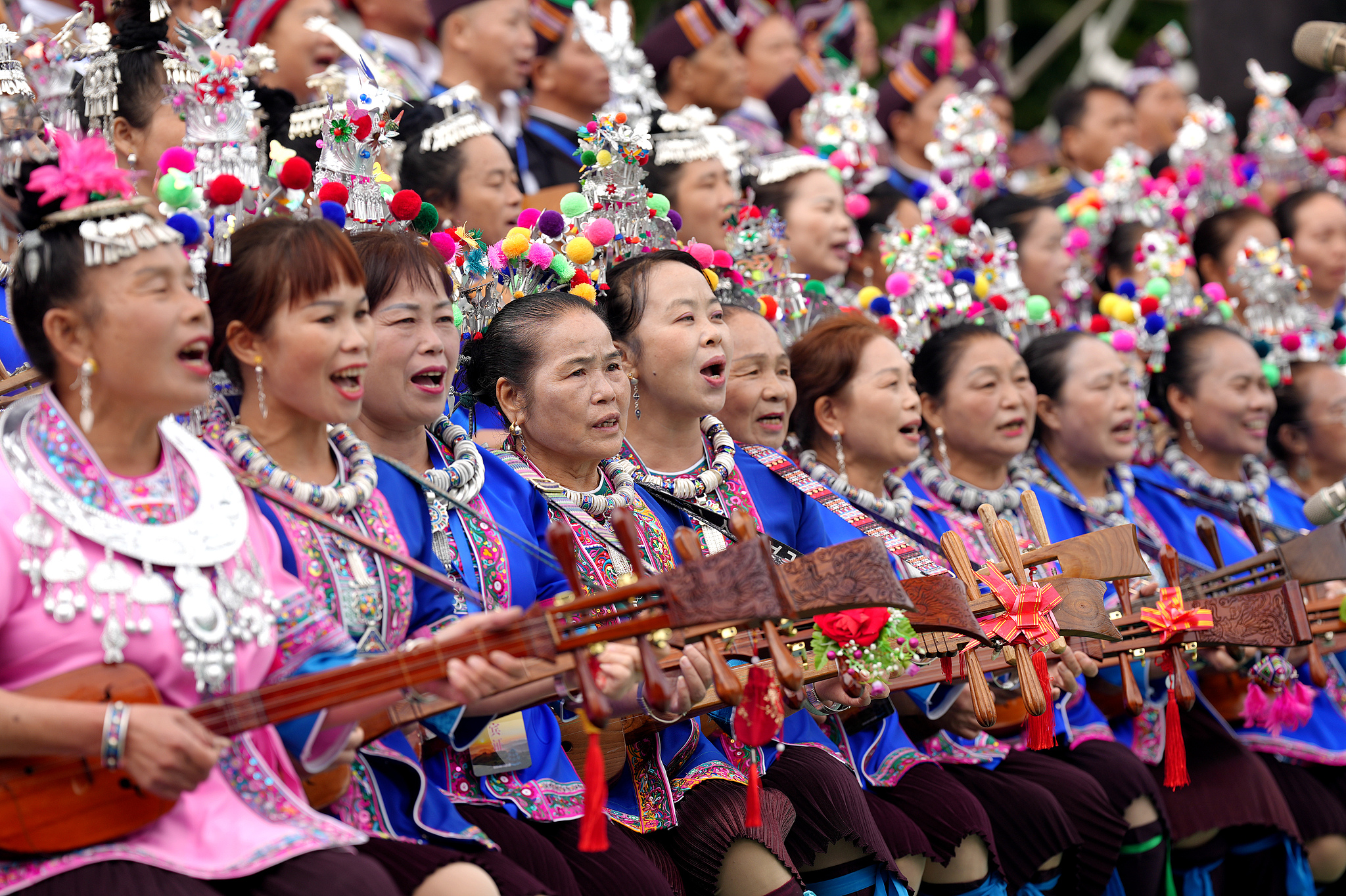 People sing while playing the pipa for National Day celebrations in Liuzhou, Guangxi on October 2, 2024. /CFP  