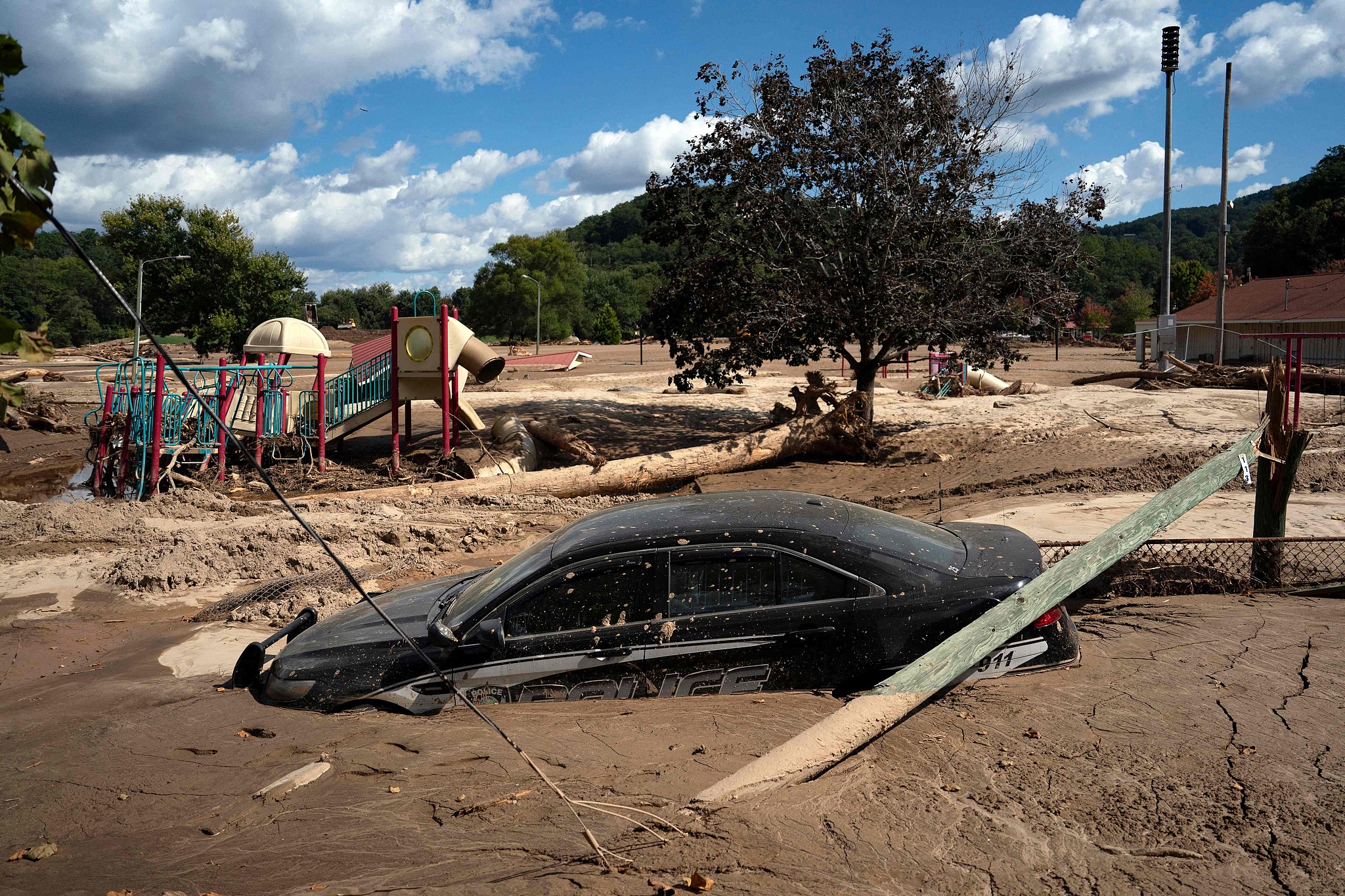 A local police car is seen half-submerged in mud in a flooded area of Lake Lure, North Carolina, after the passage of Hurricane Helene, October 2, 2024. /CFP