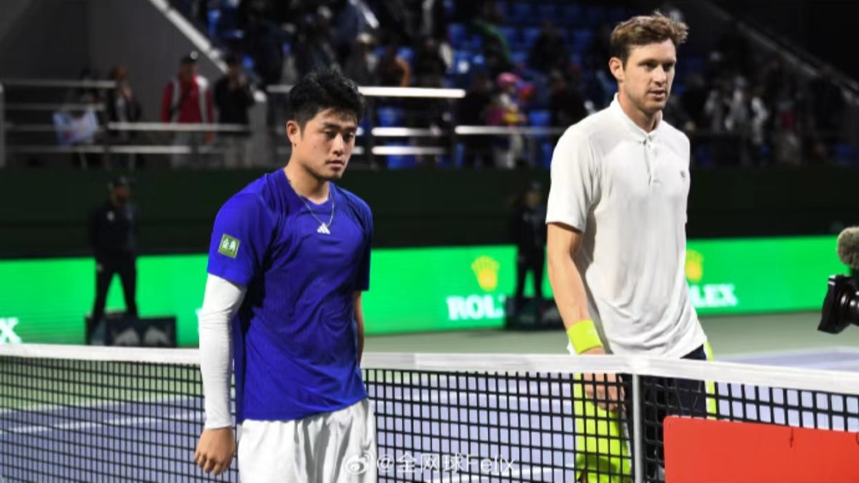 Wu Yibing (L) of China and Nicolas Jarry of Chile react at the net during their men's singles second-round match at the Shanghai Masters in east China's Shanghai Municipality, October 4, 2024. /CMG